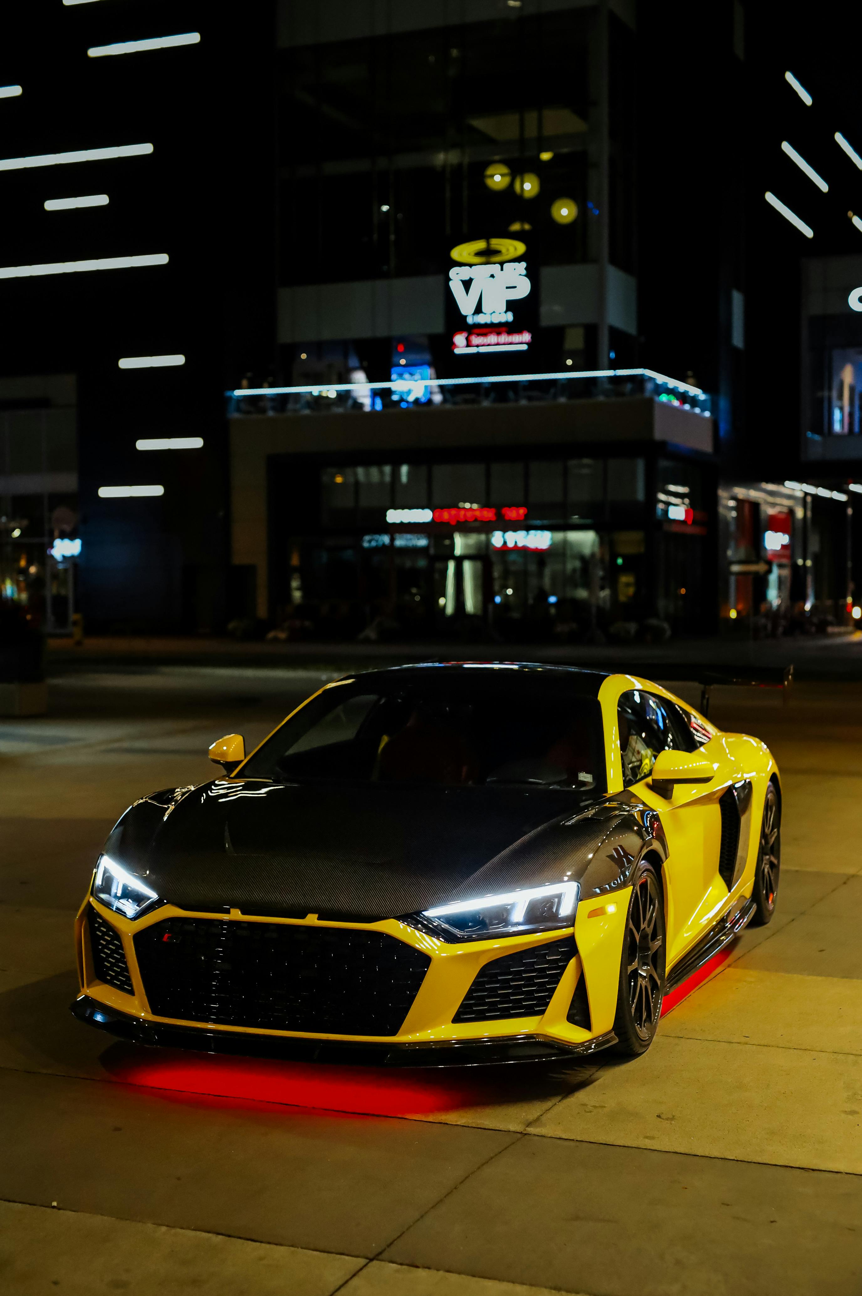 Yellow Sports Car on a Road at Dusk · Free Stock Photo