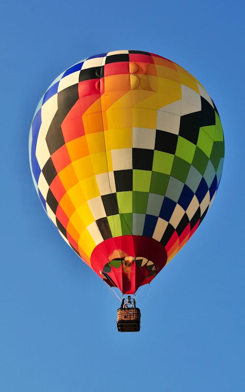 A colorful hot air balloon flying in the sky