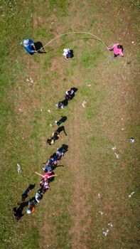 Children playing outdoors in Burdur, Türkiye, captured in a drone shot.