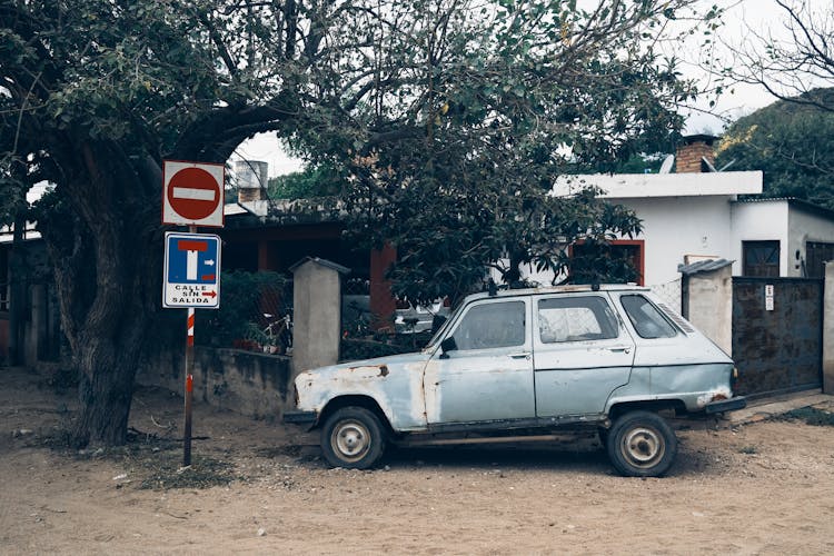 Neglected Car On Dirty Road