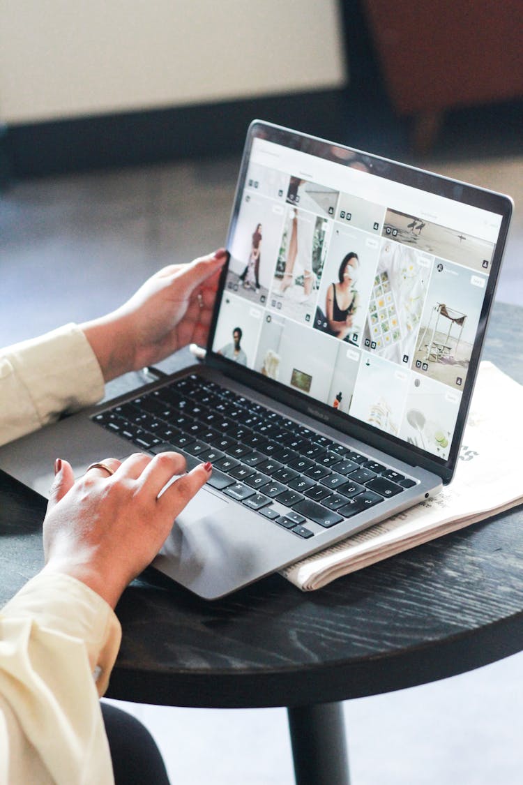 Woman Looking On Images At Laptop