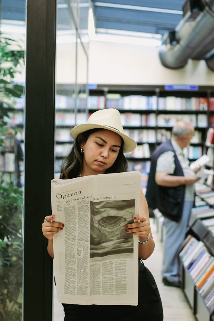 Leaning On Wall Woman Reading Newspaper