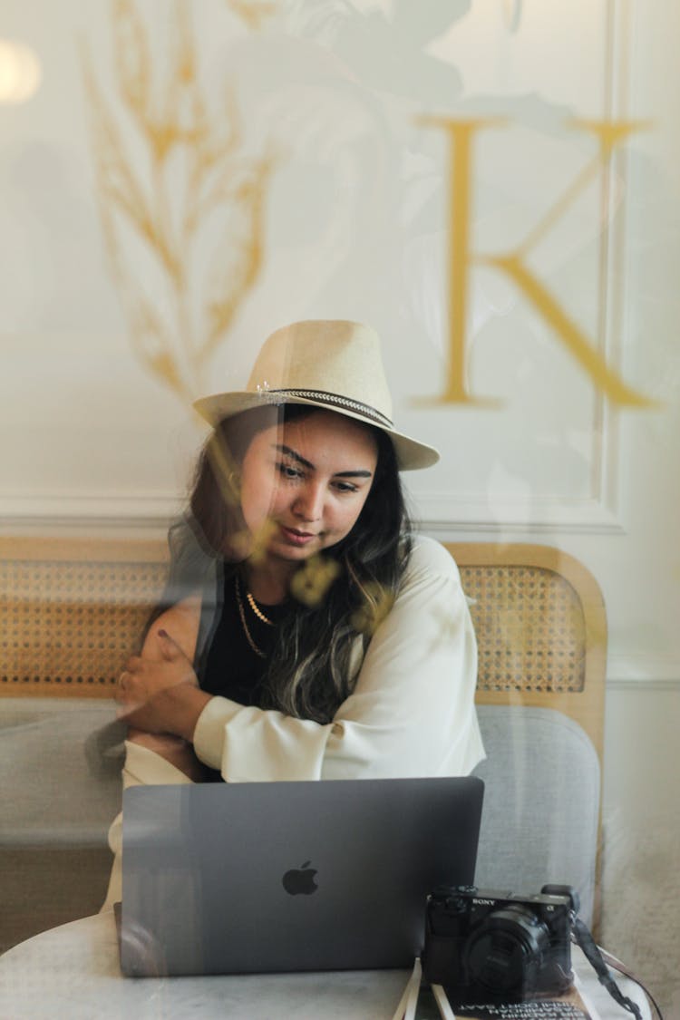 Woman Looking On Laptop In Cafe