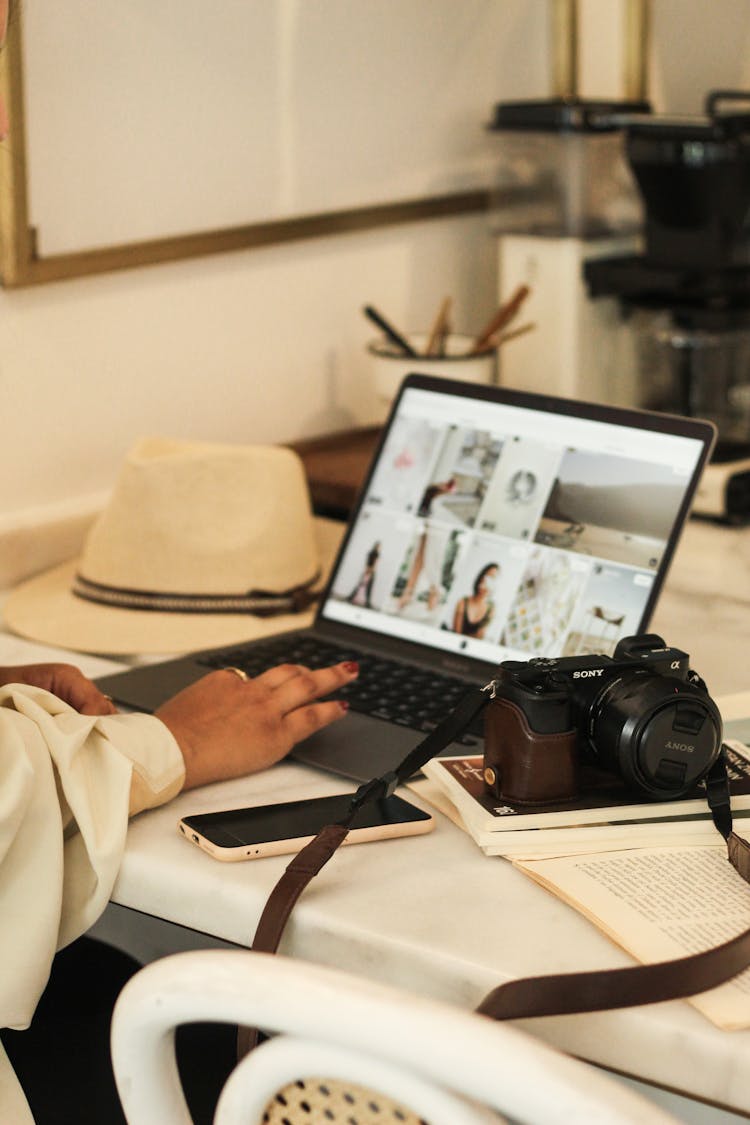 Laptop And Digital Camera On Desk