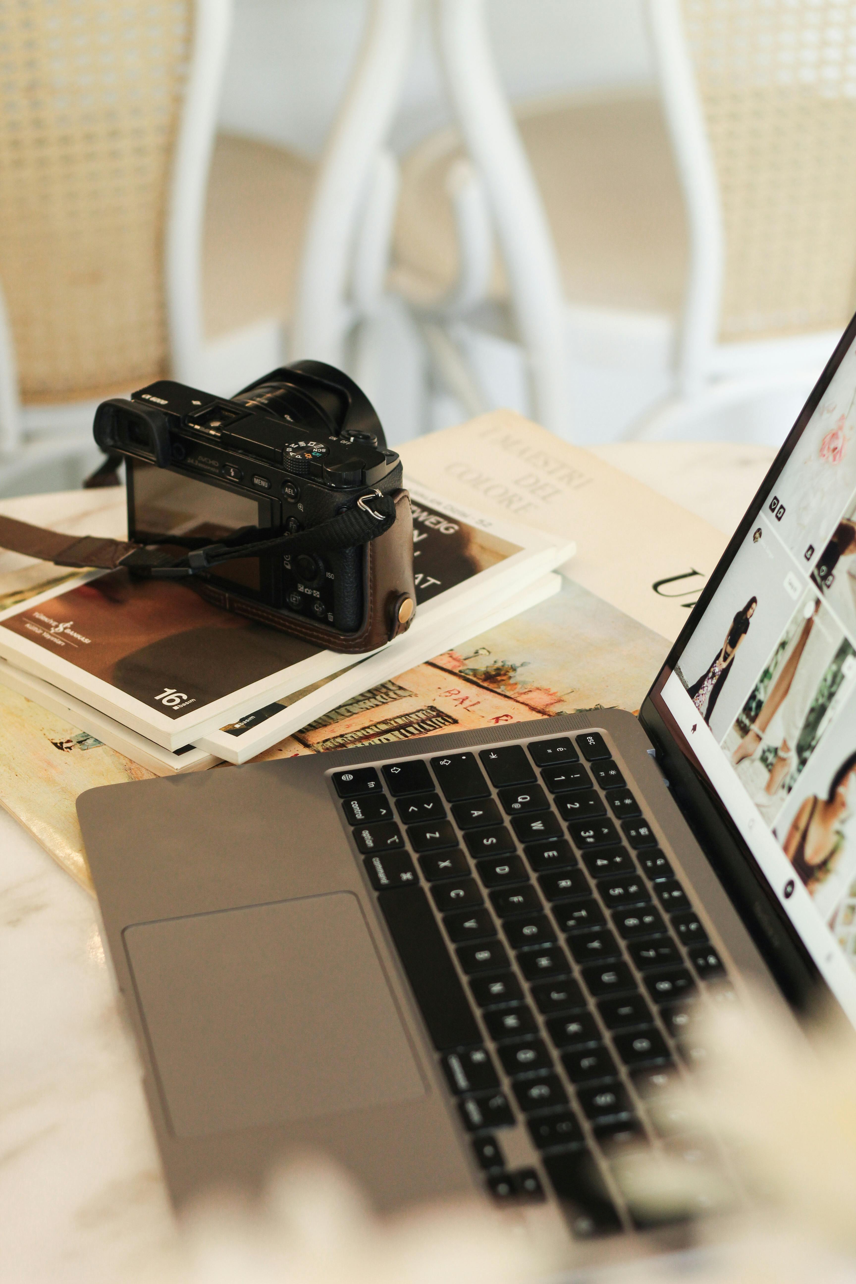 Top view of camera and laptop on desk