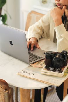 Stylish workspace featuring a laptop and camera on a desk.