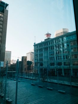 Cityscape featuring modern and historic architecture under a clear sky.