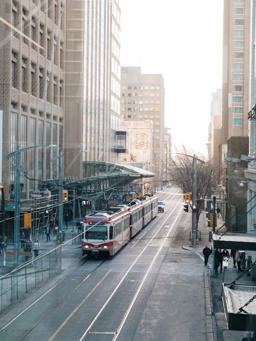 A Tram on the Street between Modern Buildings 