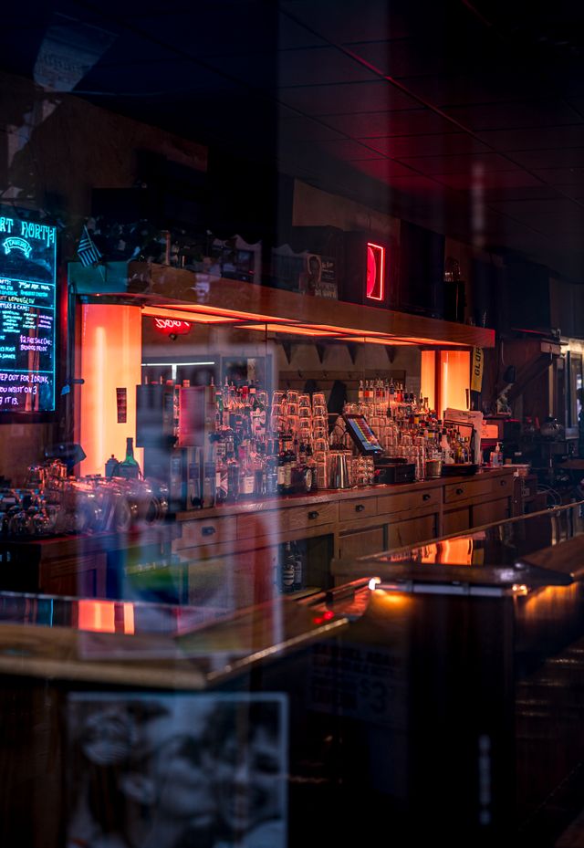 The bar glowing at night when it is closed to the public