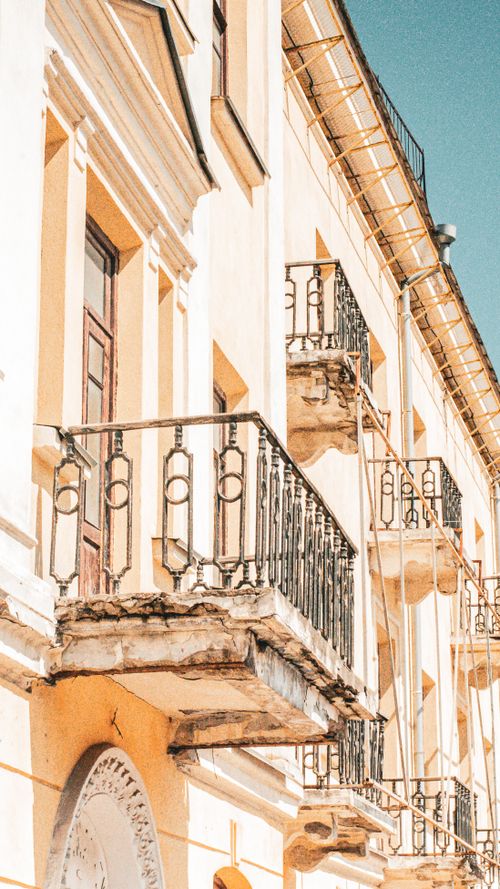 Free Beautiful sunlit balconies on a historic building in Kamianets-Podilskyi, Ukraine. Stock Photo