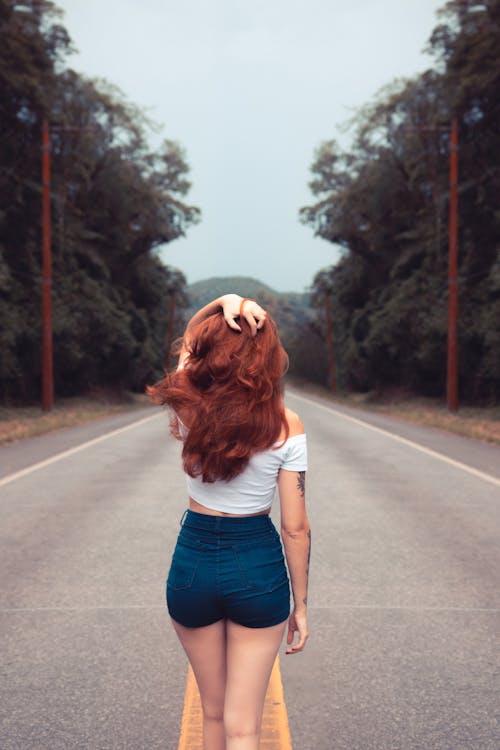 Free Woman Standing on Road Stock Photo