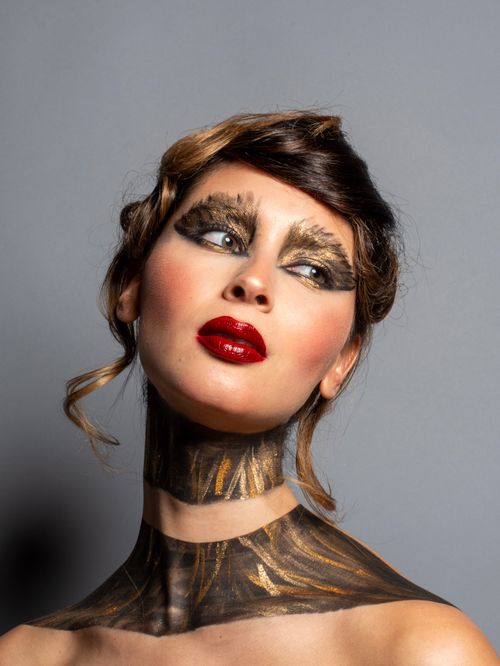 Free Captivating fashion portrait showcasing bold makeup and artistic body paint. Stock Photo