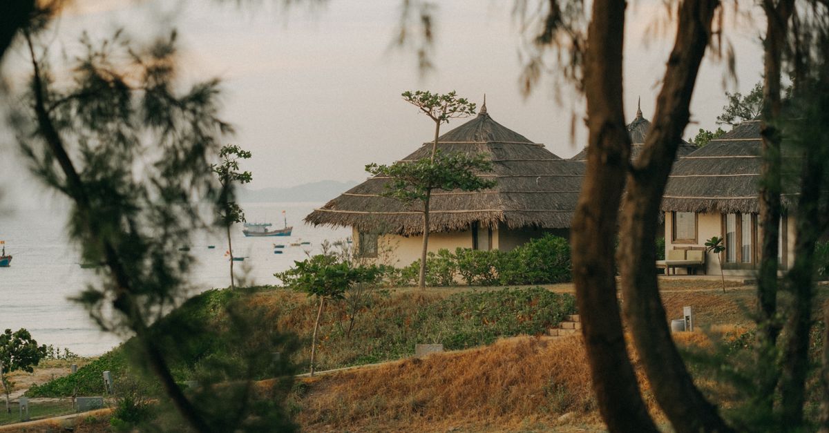 quiet tropical island beach with wooden bungalow at sunrise, Southeast Asia