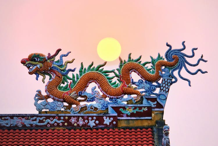 Moon Over A Traditional Chinese Dragon Shaped Roof Decoration