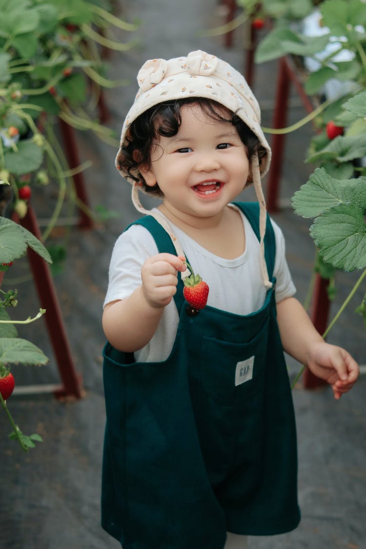 Smiling Baby Girl With Strawberry