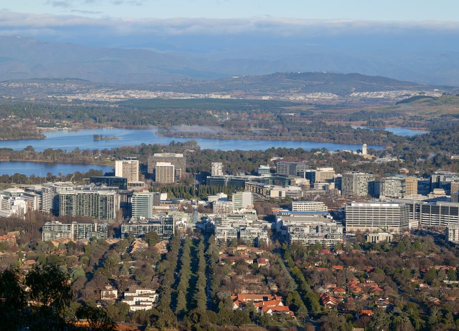 Scenic aerial cityscape of Canberra, Australia's capital, showcasing urban and natural elements.