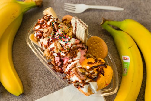 Ice Cream with Cookies and Sprinkles and Bananas on the Table 