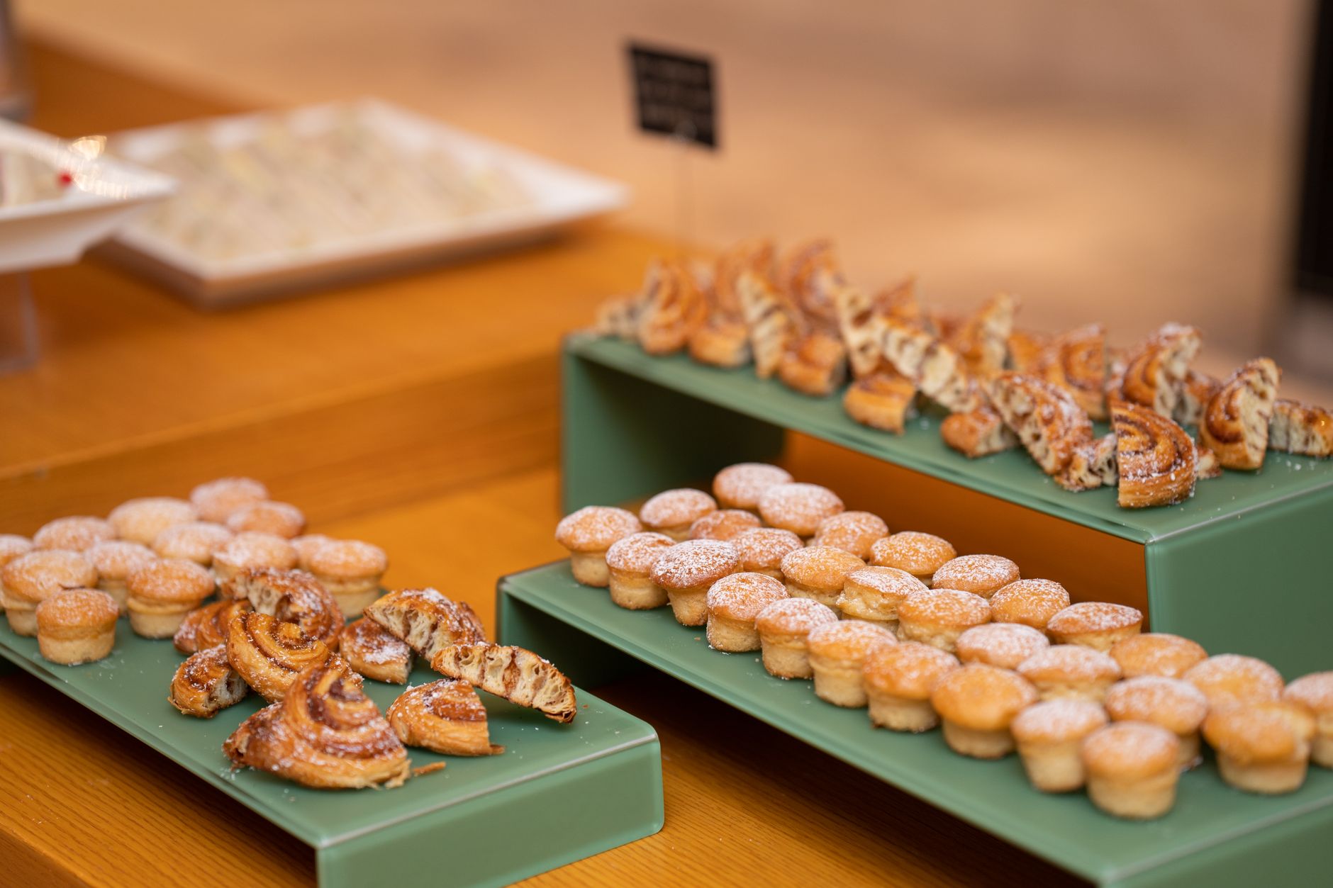 Delicious assortment of mini pastries beautifully displayed at a bakery. Perfect for a sweet indulgence.