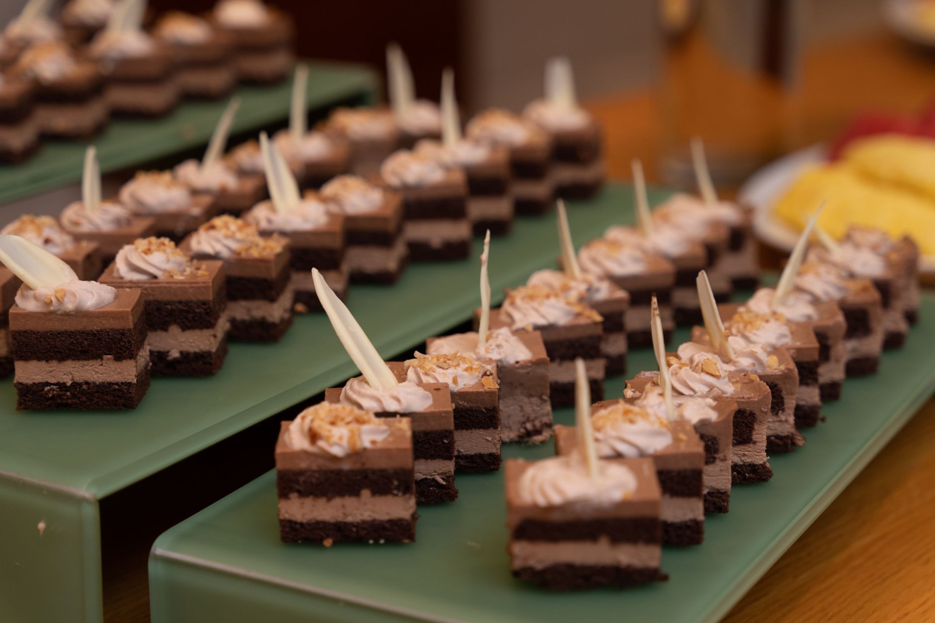 Indulge in these rich chocolate dessert squares topped with cream, perfect for any sweet table.