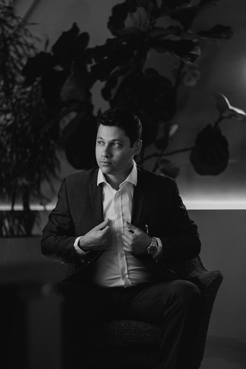 Elegant Man in a Suit Sitting in an Armchair 