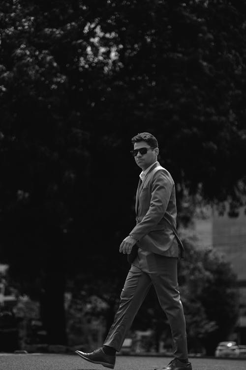 Man in Suit Walking in Black and White
