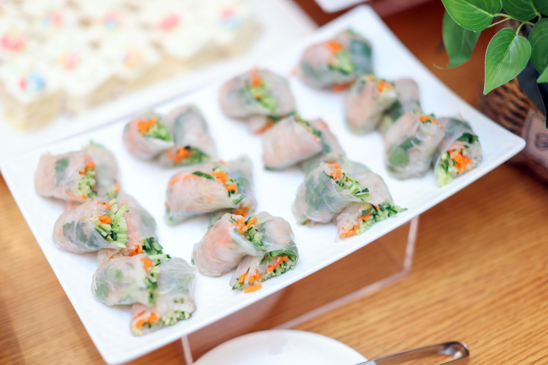 Delicious Vietnamese spring rolls filled with fresh vegetables on a white plate, perfect for a healthy meal.
