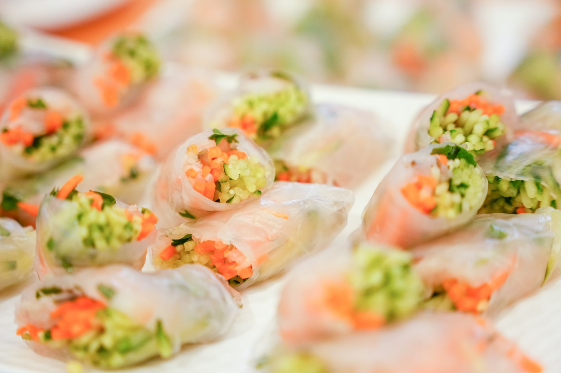 Close-up of colorful vegetable spring rolls wrapped in rice paper, perfect for a healthy snack.