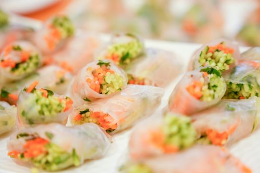 Close-up of colorful vegetable spring rolls wrapped in rice paper, perfect for a healthy snack.