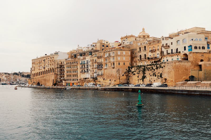 Historic waterfront buildings along the harbour in Valletta Malta with traditional limestone architecture