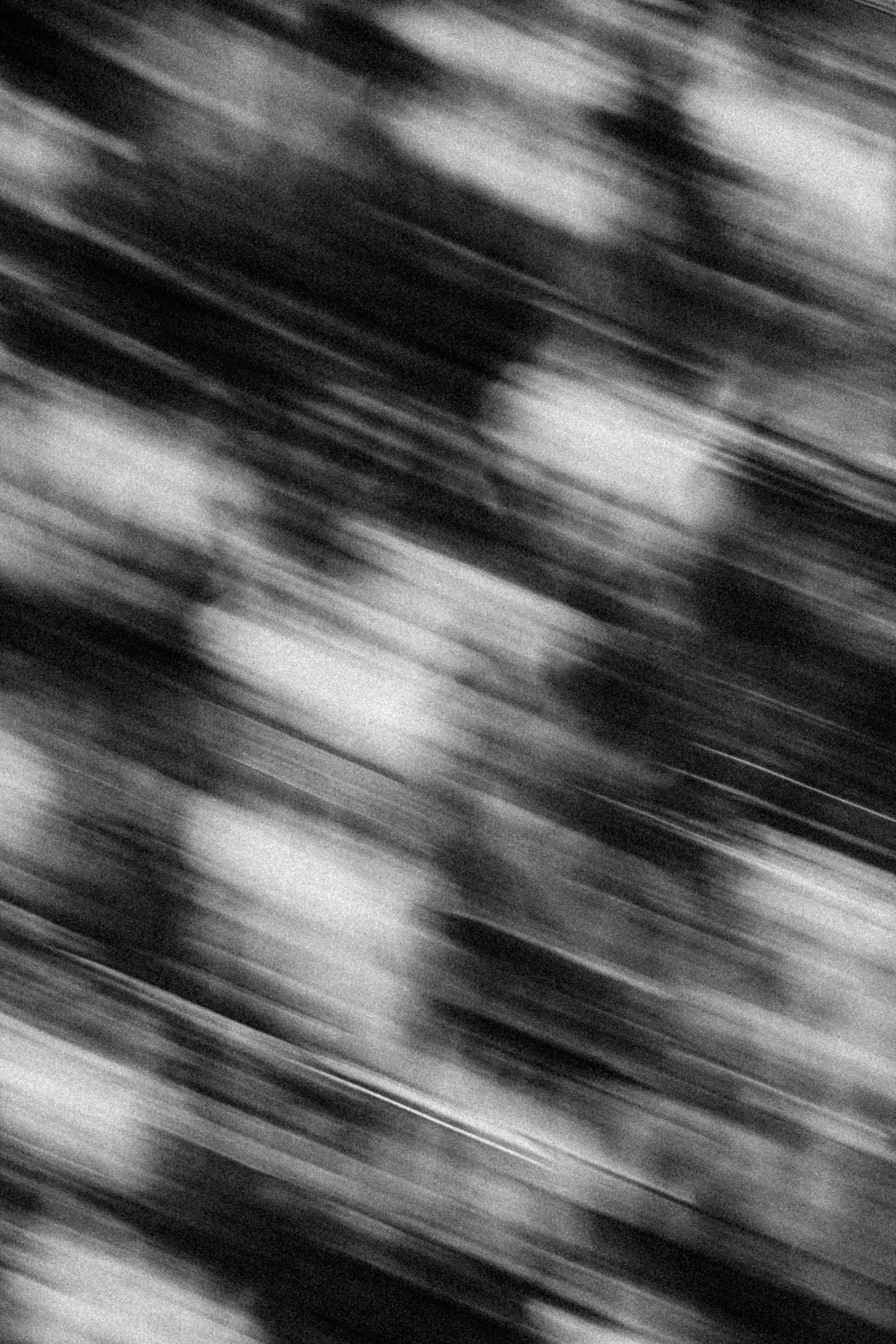 Blurred abstract black and white image with dynamic motion lines.