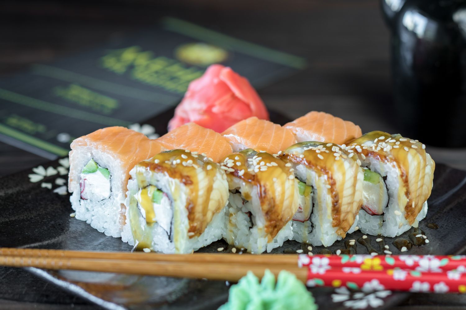 Sushi rolls and nigiri served on a dark plate