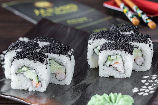 Appetizing sushi rolls topped with black caviar, served stylishly on a dark plate in Istanbul.