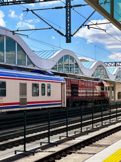 Free Colorful trains at a modern Turkish station under a bright blue sky. Stock Photo