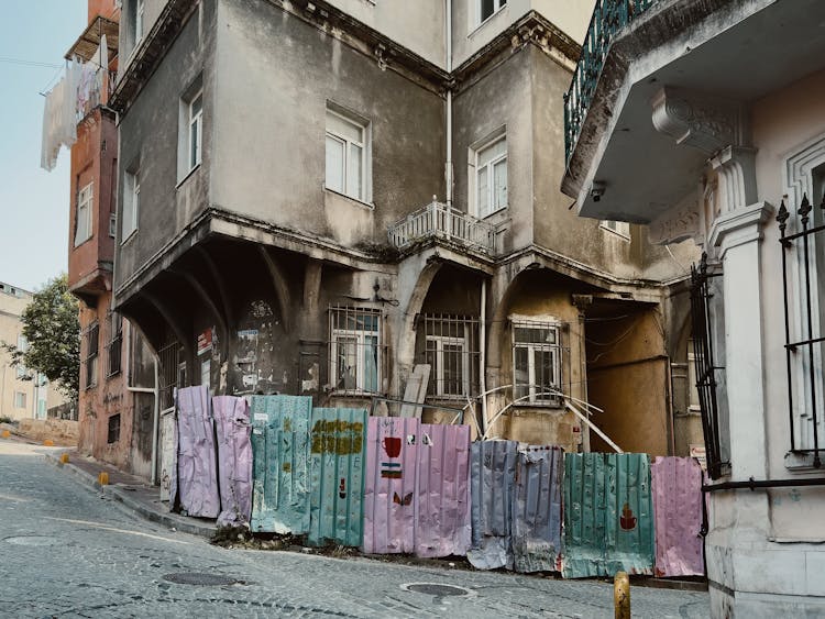 Damaged Wall Near Building By Street