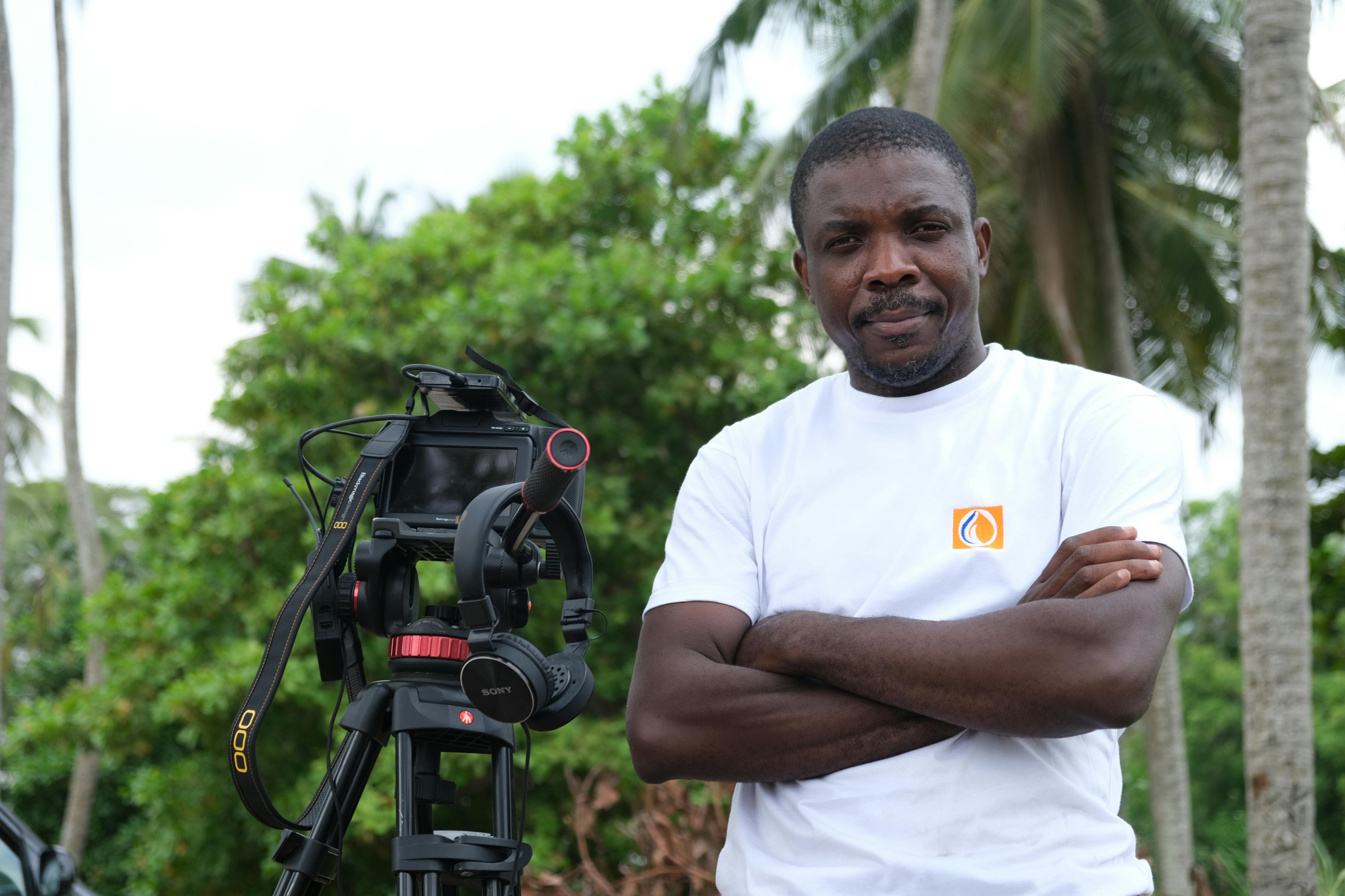 African Man with a Camera Among Tropical Trees · Free Stock Photo