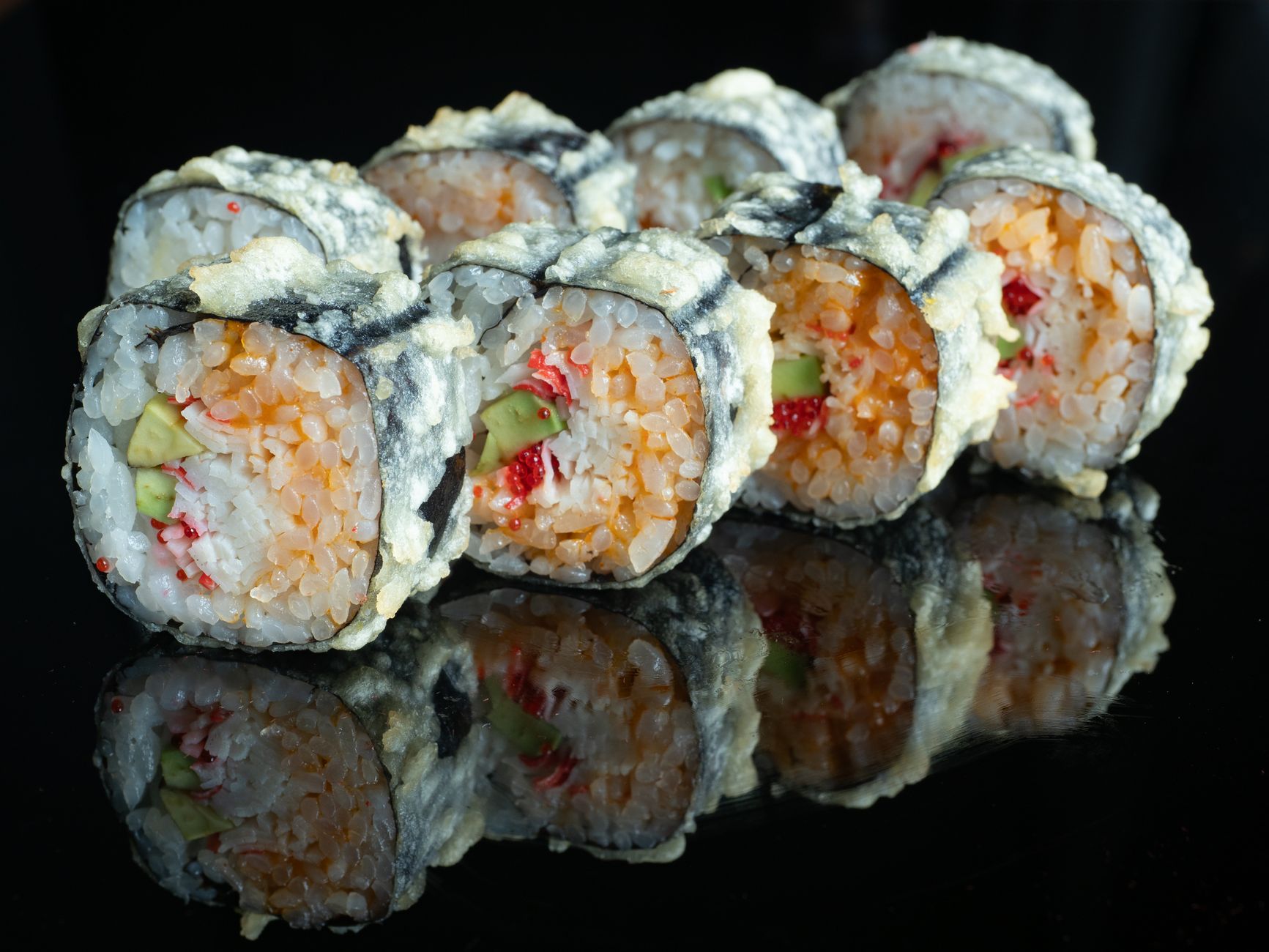 Vegetables being fried in tempura batter in hot oil