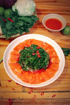 Freshly plated salmon and greens with vibrant garnishing, perfect for healthy meals.