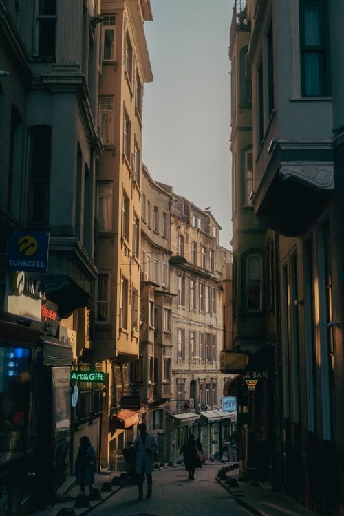 Free Discover a quaint narrow alleyway in Istanbul, captured at dusk, featuring historic rowhouses and a serene atmosphere. Stock Photo