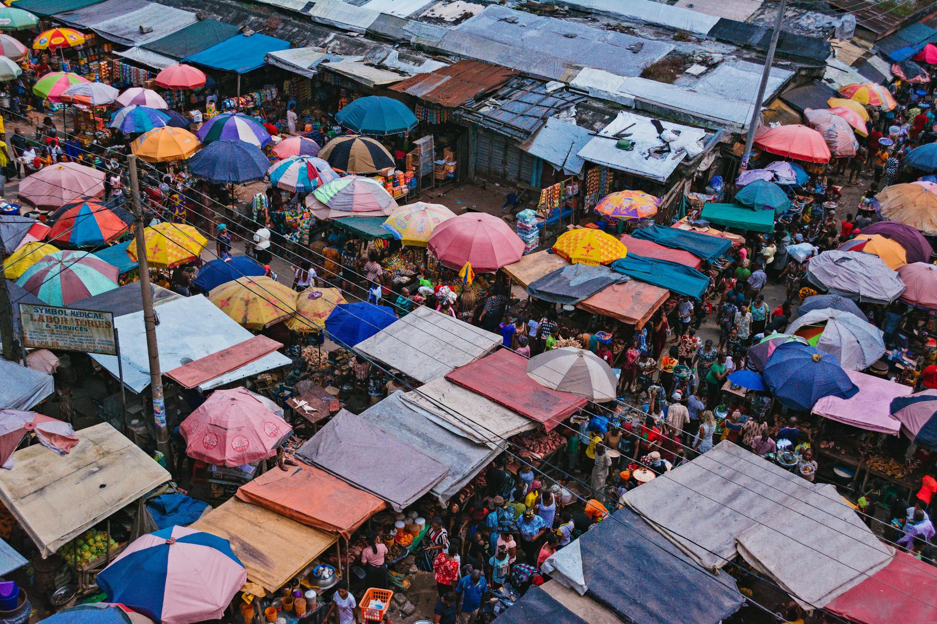 Vibrant aerial shot capturing the colorful stalls and bustling crowd of Aba market in Nigeria.