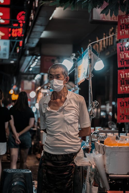 Elderly Man Wearing a Face Mask on a Street Market 