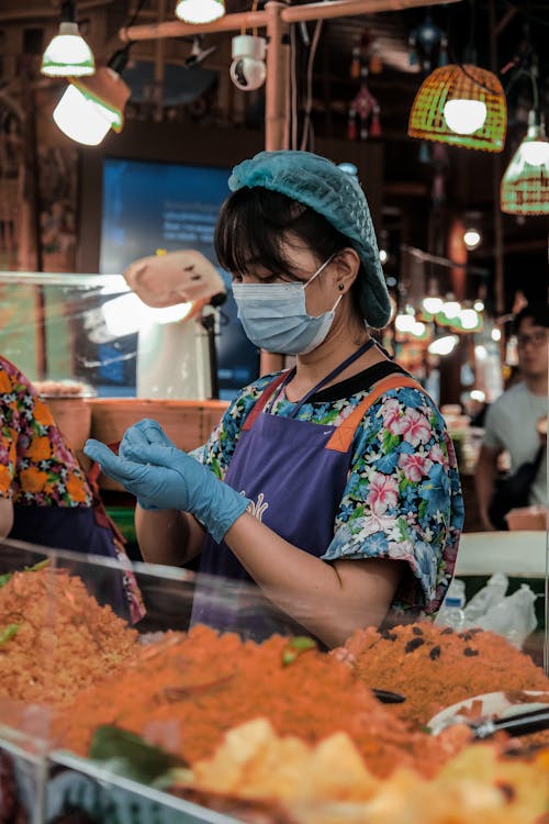 Woman in Mask Working at Bazaar