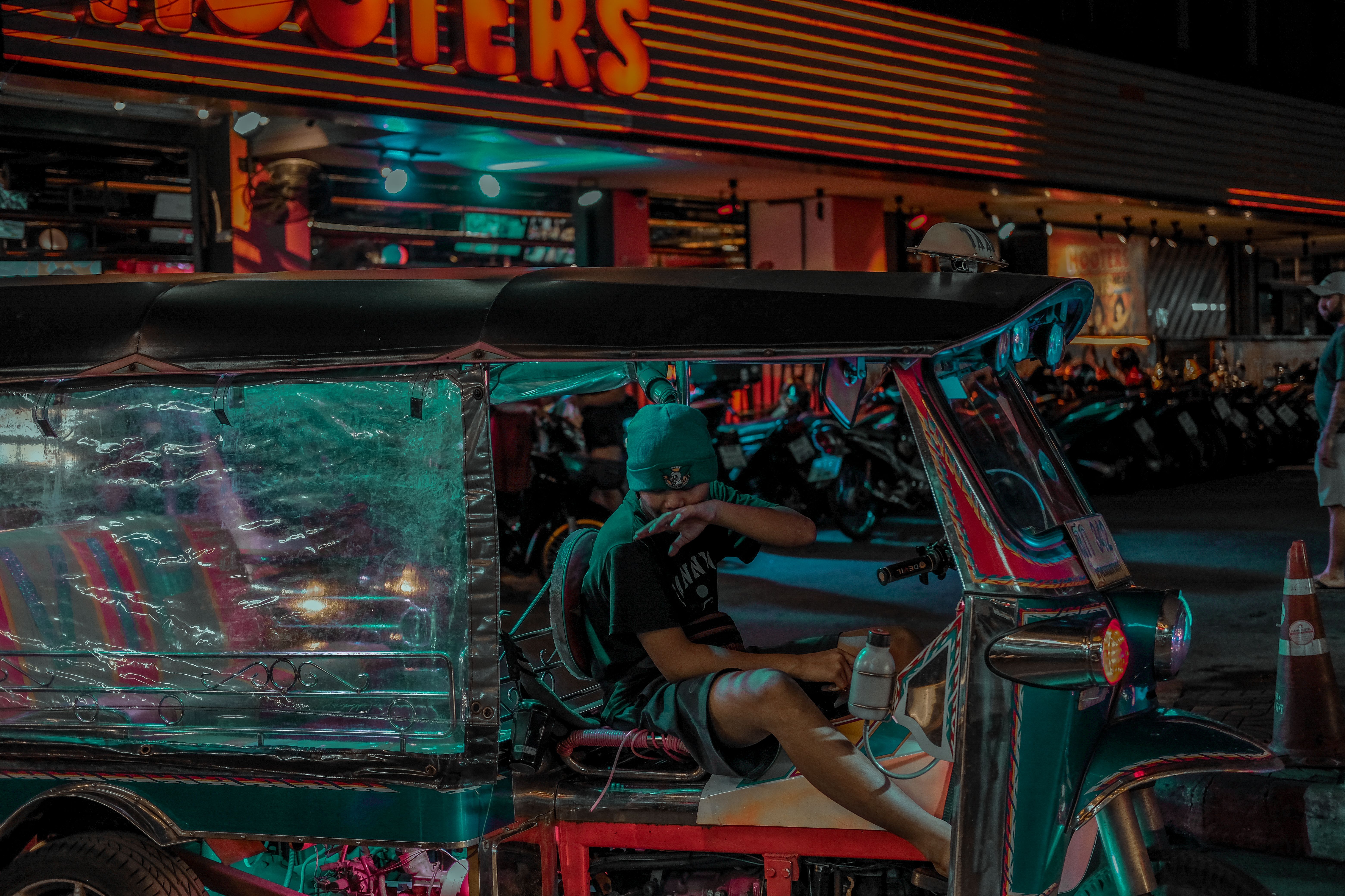 A man sitting in a car at night · Free Stock Photo