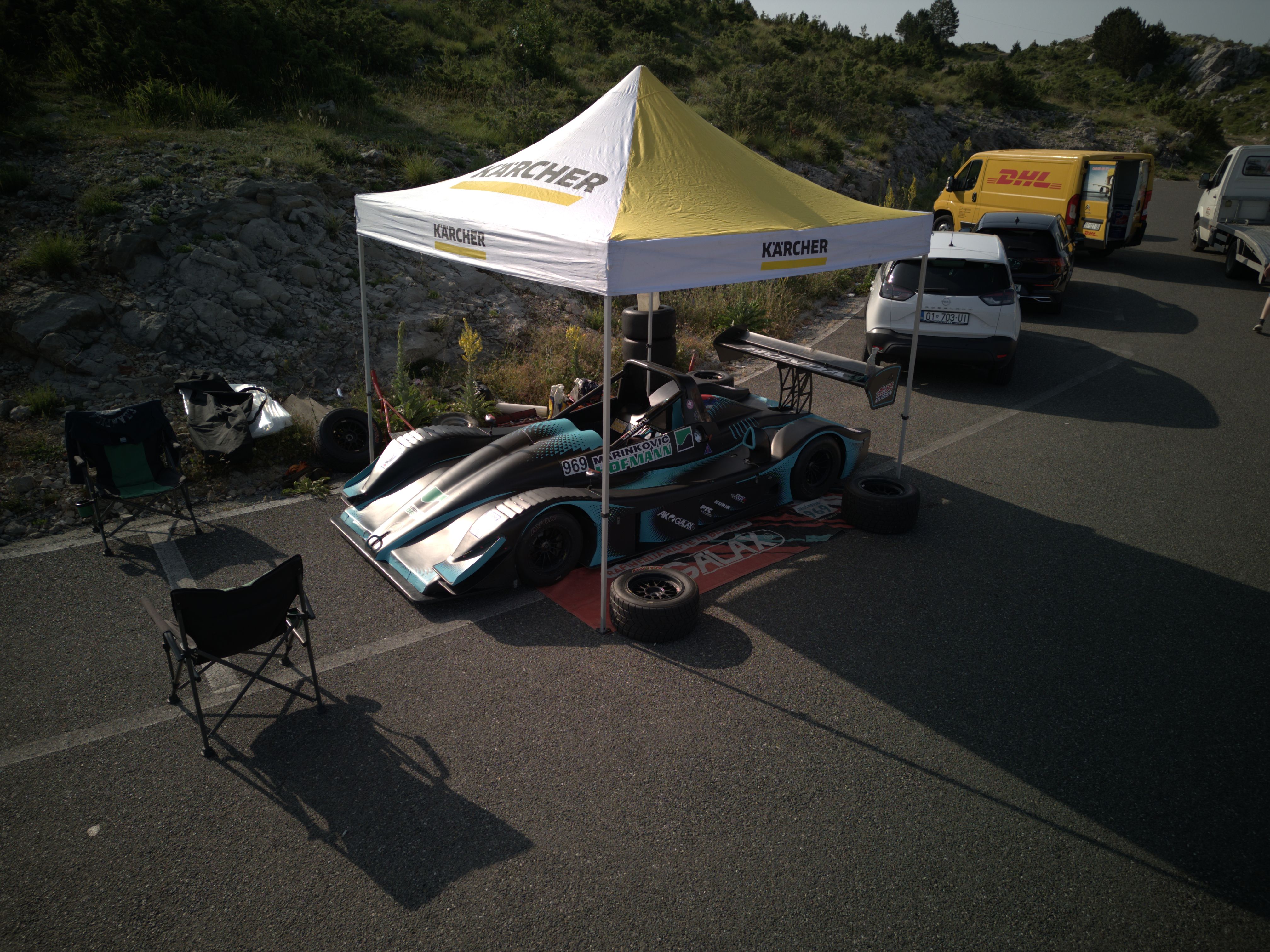 High-angle view of a racing car setup under a tent in Kruje, Albania.