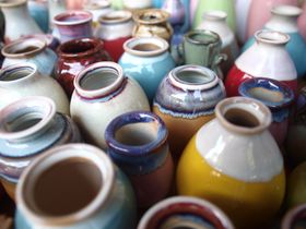 Rows of glazed stoneware pots, photo by mingche lee on Pexels