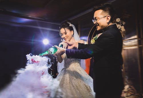 Smiling Newlyweds Pouring Champagne