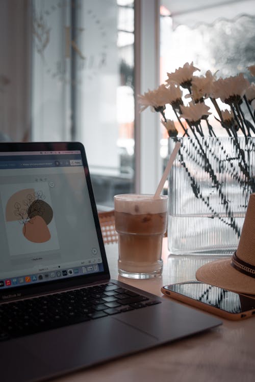 Coffee in Glass and Laptop on Cafe Table