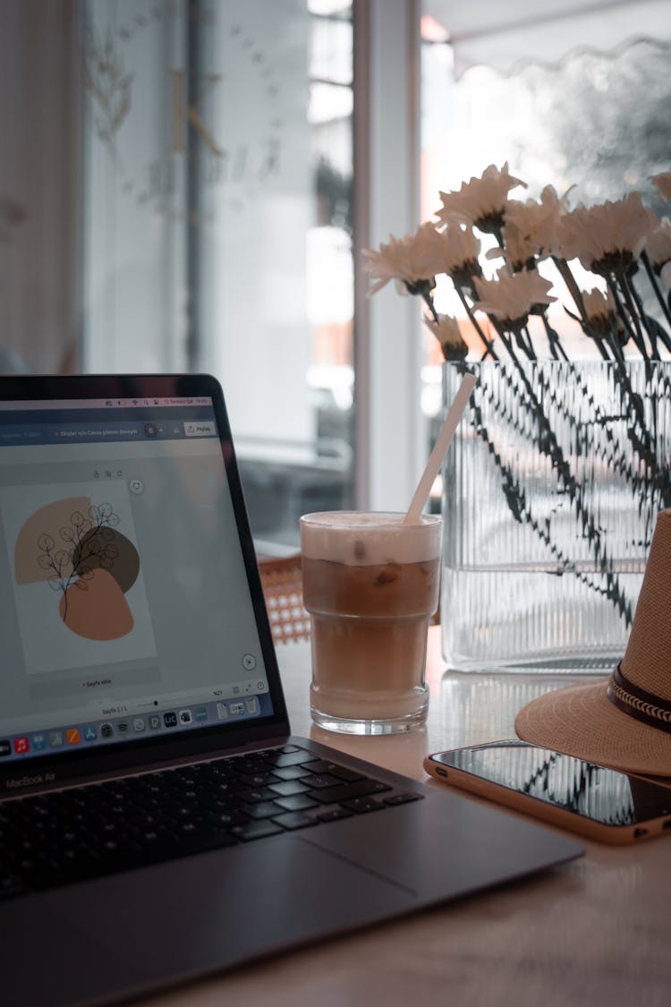 Coffee In Glass And Laptop On Cafe Table