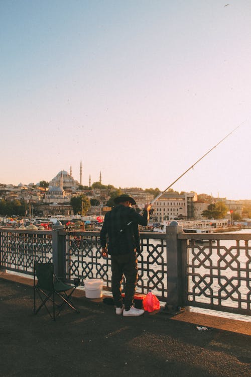 A Man Fishing from the Bridge over the Bosphorus Strait in Istanbul, Turkey 