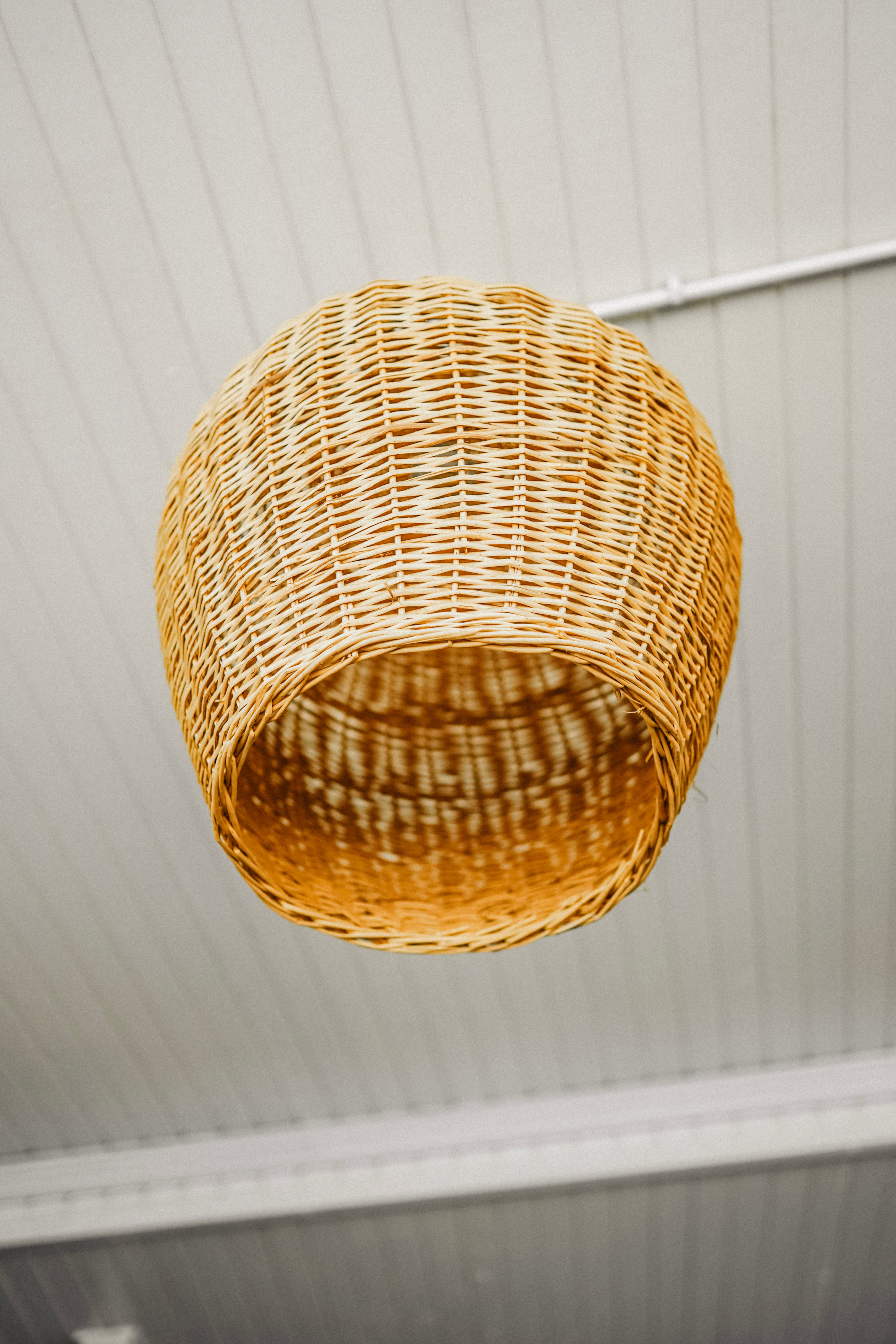 woven rattan pendant light hanging above a small coffee station