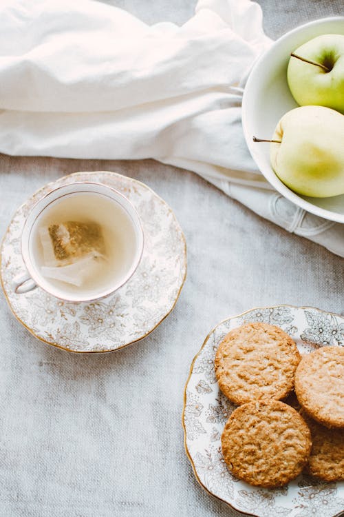 Free Bowl of Apples, Plate of Biscuits, and Teacup Stock Photo
